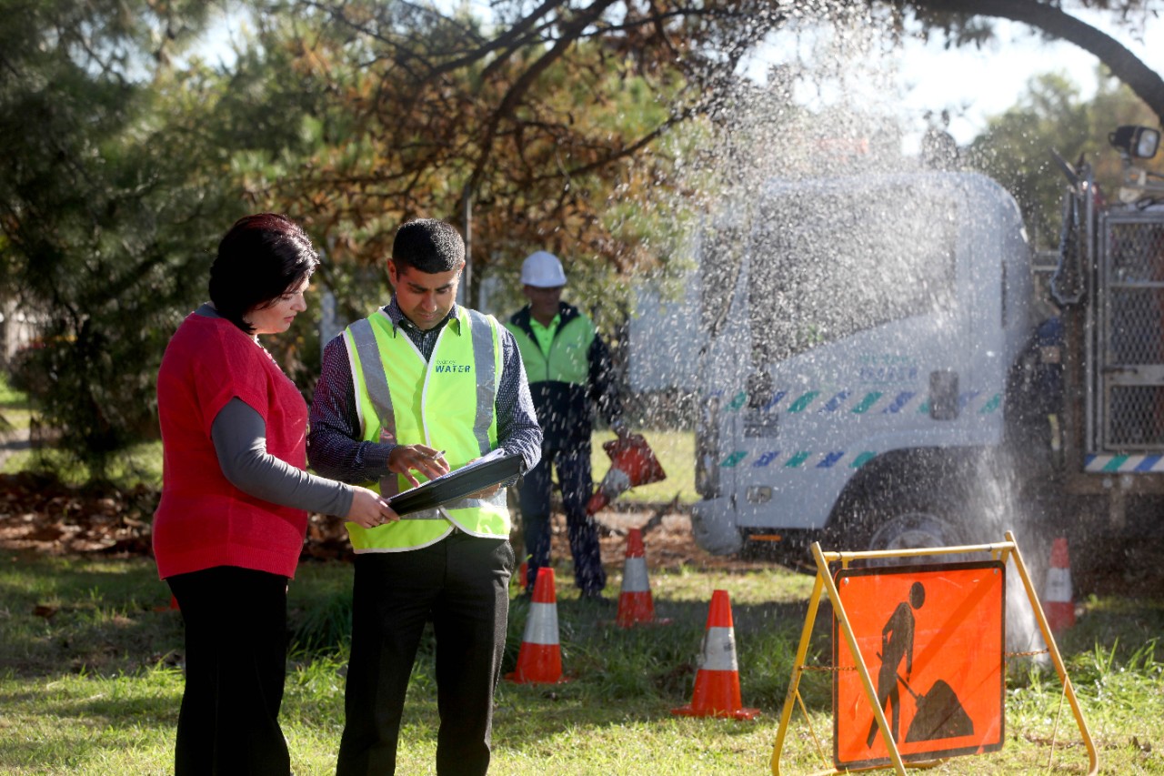 Our crew speaking with a customer while fixing water main break 